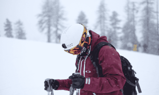 Person in maroon ski jacket skiing