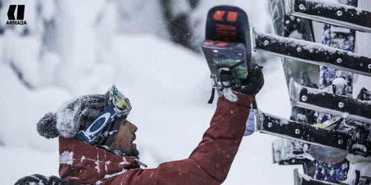 Skier placing Armada skis on a ski rack