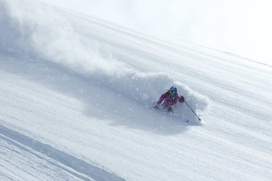 Skier out spring skiing in deep powder