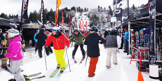 Skiers and snowboarders checking out demo day tents