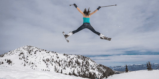 Woman skier in the air after going off a jump